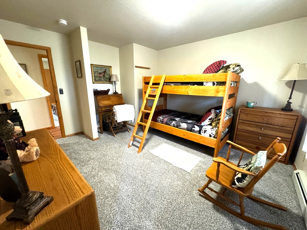 down the hall on the left is the second guest bedroom with bunk beds