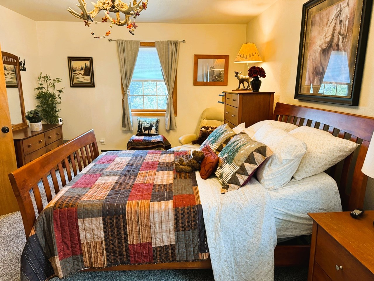 the primary bedroom with a view out the front window