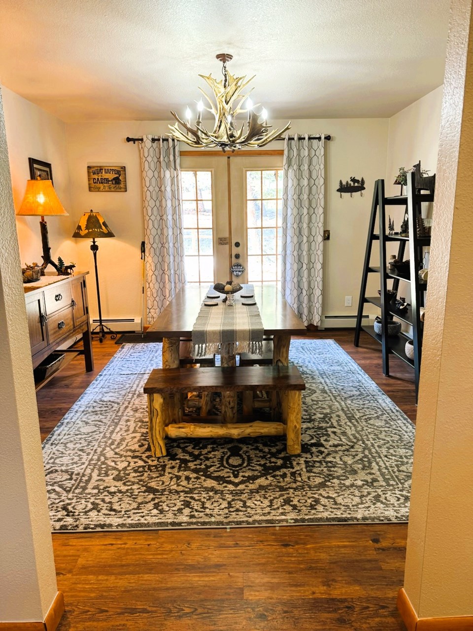 an inviting dining room with french doors out to the back deck