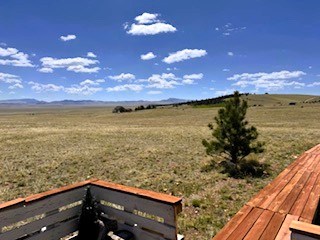 view from the deck across the property to the surrounding mountains