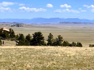 zoomed view northwest from the deck across the property to the mountains