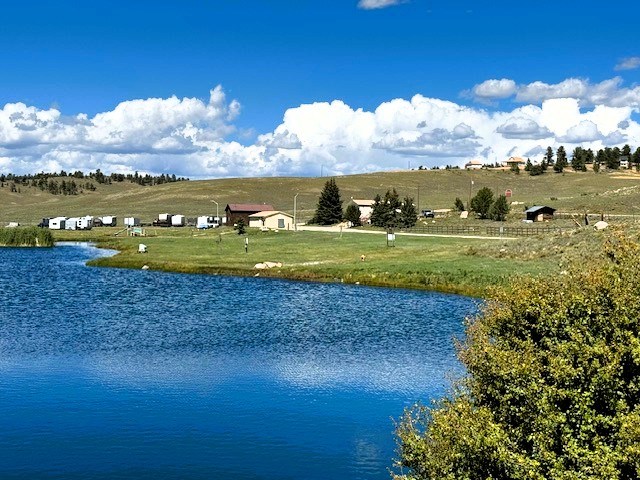 the hoa's fishing pond with the rv storage lot, fire station and caretaker's home a short distance from the pond's banks