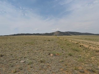 view west along the front of the lot and mesa road from the northeast corner marker
