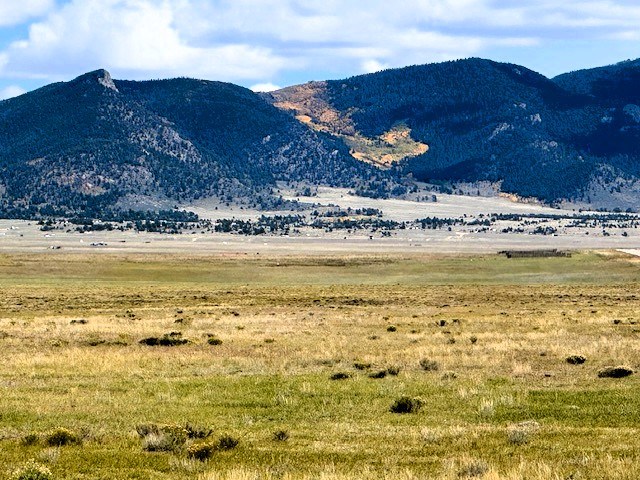 zoomed northeast to mountains just north of badger mountain with golden aspens flowing between mountain peaks