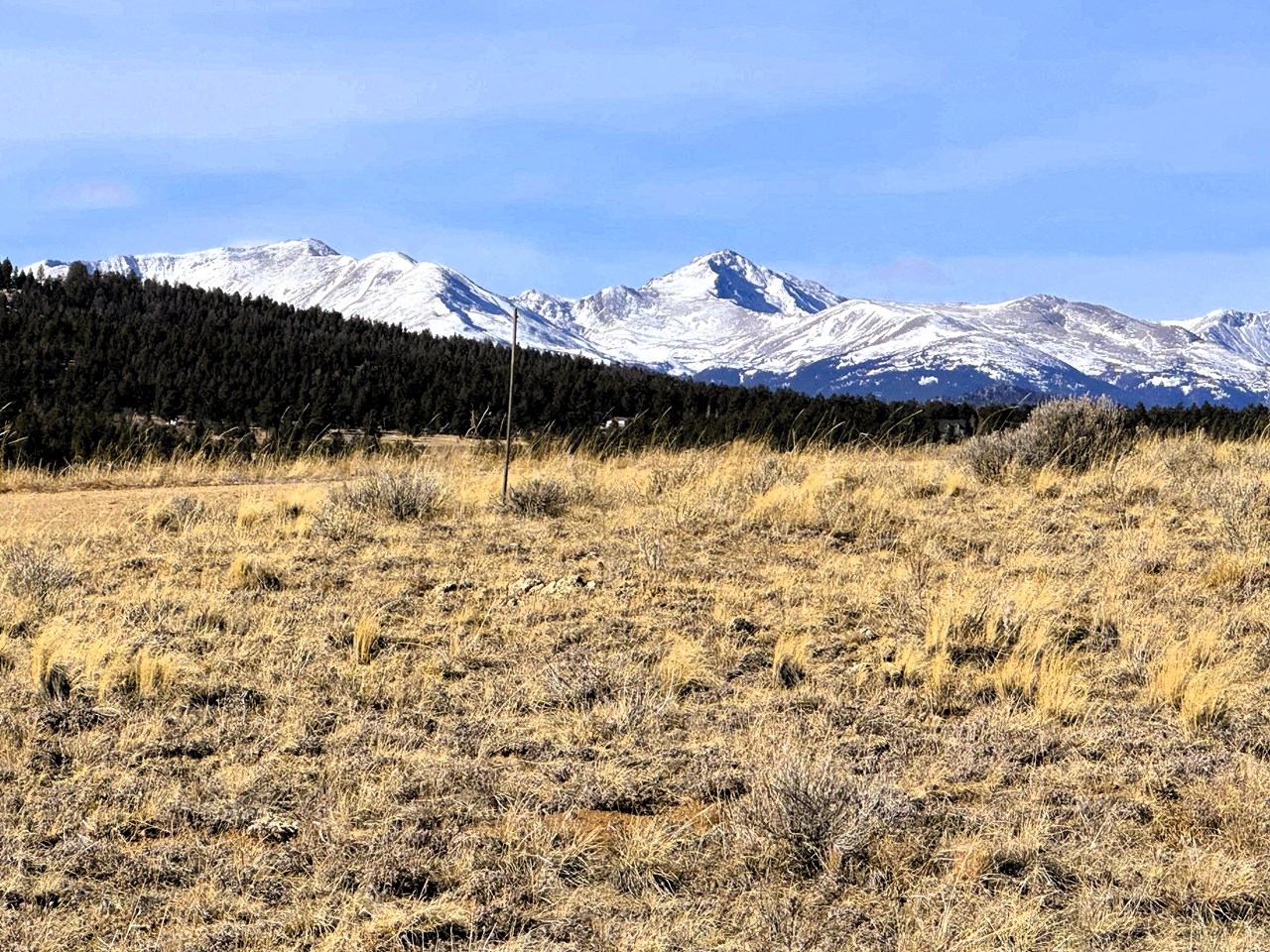 zoomed view southwest to snow capped mountains from inside the front of the property
